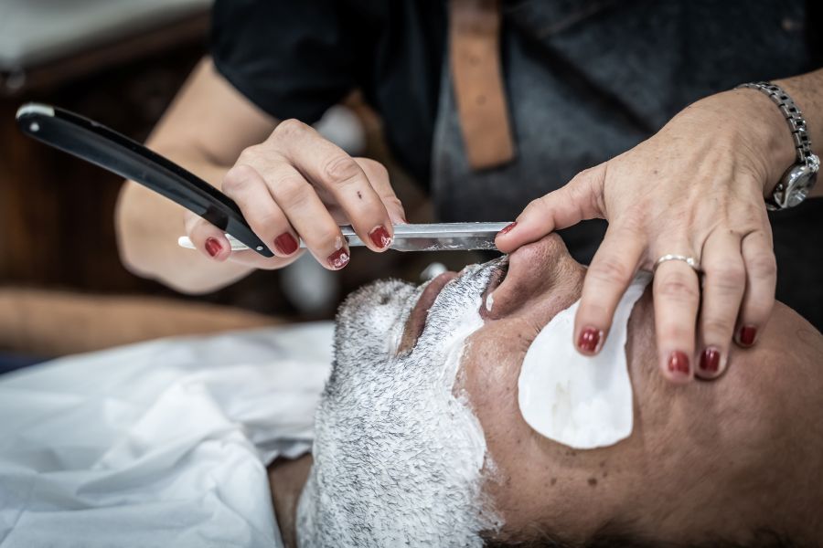 barber shaving a relaxed customer in a barber shop 2026 03 17 07 13 25 utc