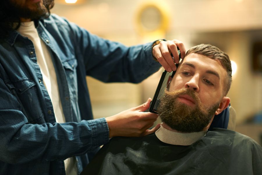 man getting haircut and beard trim at barbershop 2026 03 25 00 55 26 utc